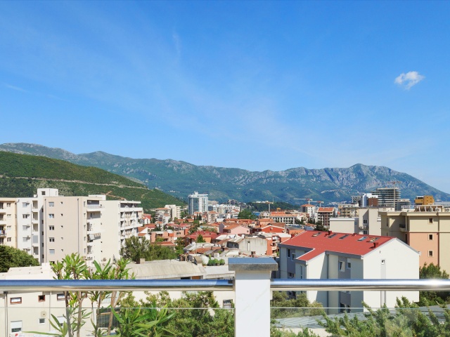 Three bedroom apartment with access to the roof and garage space in Budva