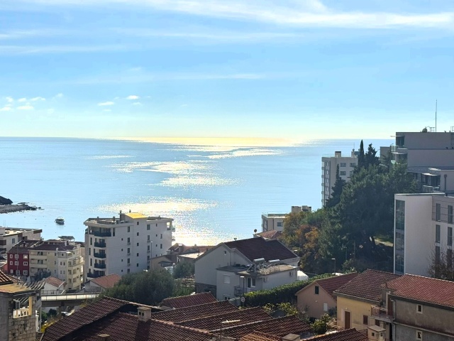 Luxury penthouse with panoramic sea views, rooftop terrace.