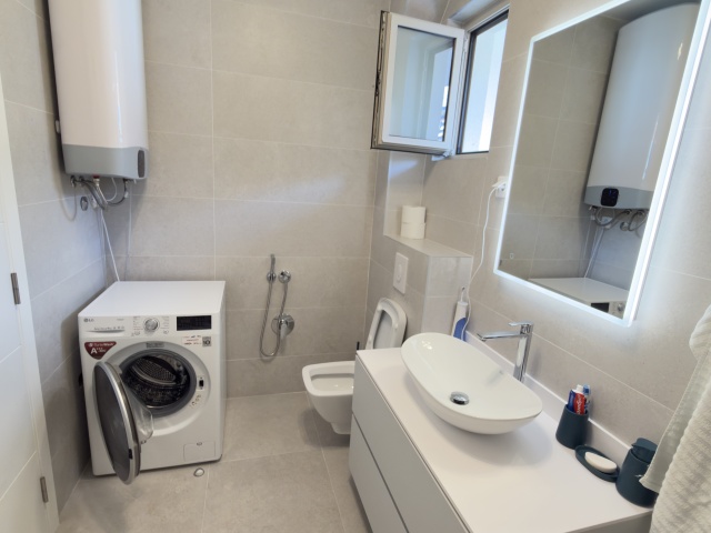 Luxury penthouse with panoramic sea views, rooftop terrace.